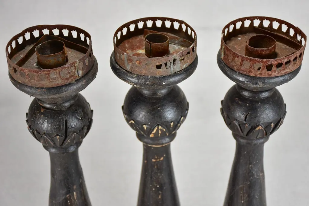 Three twentieth-century French wooden candlesticks with black paint finish 15"