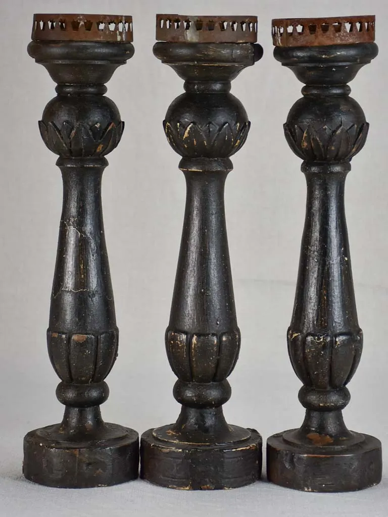 Three twentieth-century French wooden candlesticks with black paint finish 15"