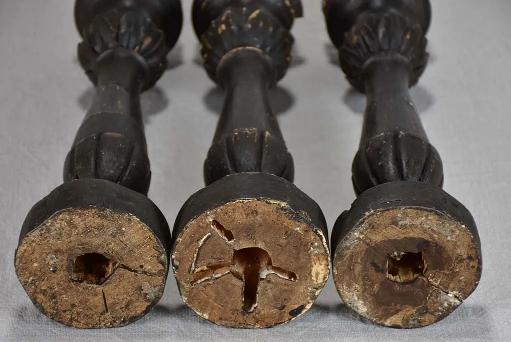 Three twentieth-century French wooden candlesticks with black paint finish 15"