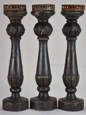 Three twentieth-century French wooden candlesticks with black paint finish 15"