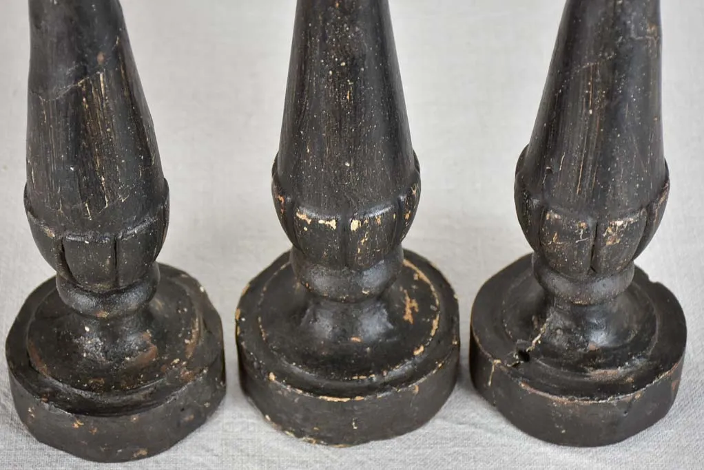 Three twentieth-century French wooden candlesticks with black paint finish 15"